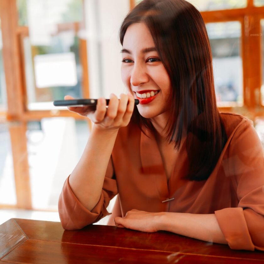woman using her smart phone to leave a voice note