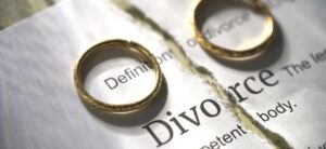 the word divorce ripped in half with a ring on each side