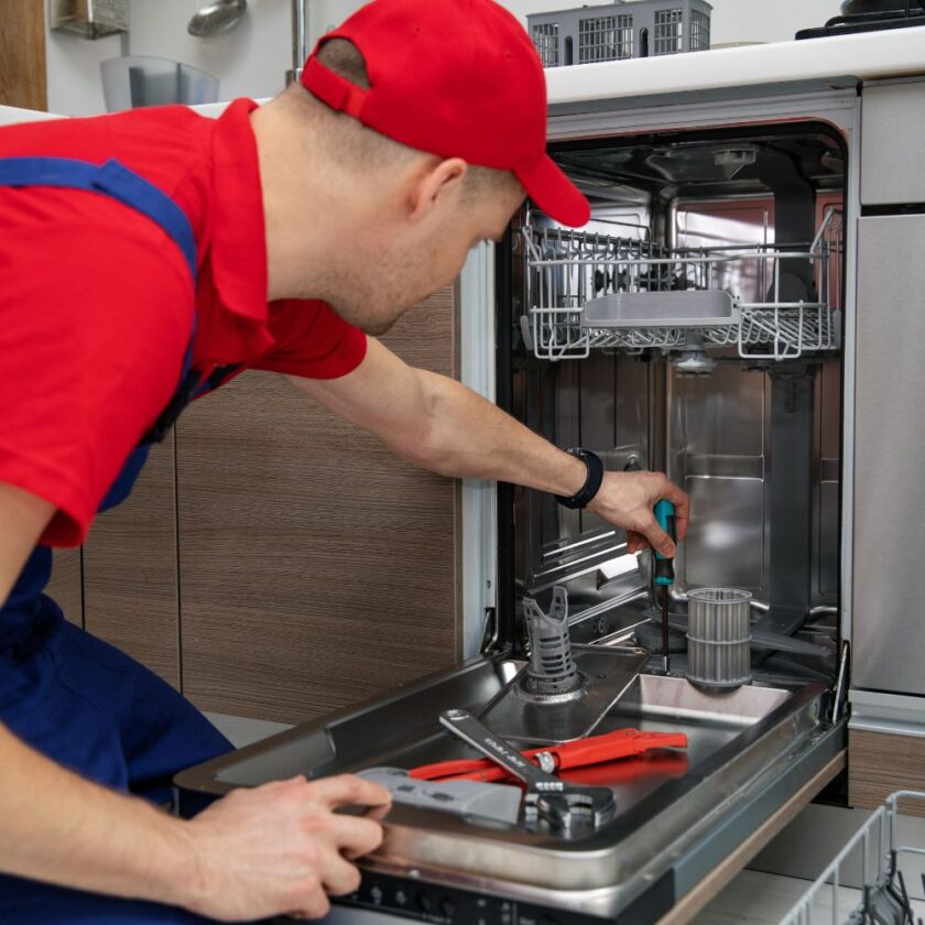 person repairing a dishwasher