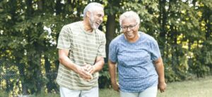 two older people walking outside