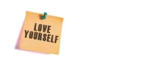 love yourself written on a post it note