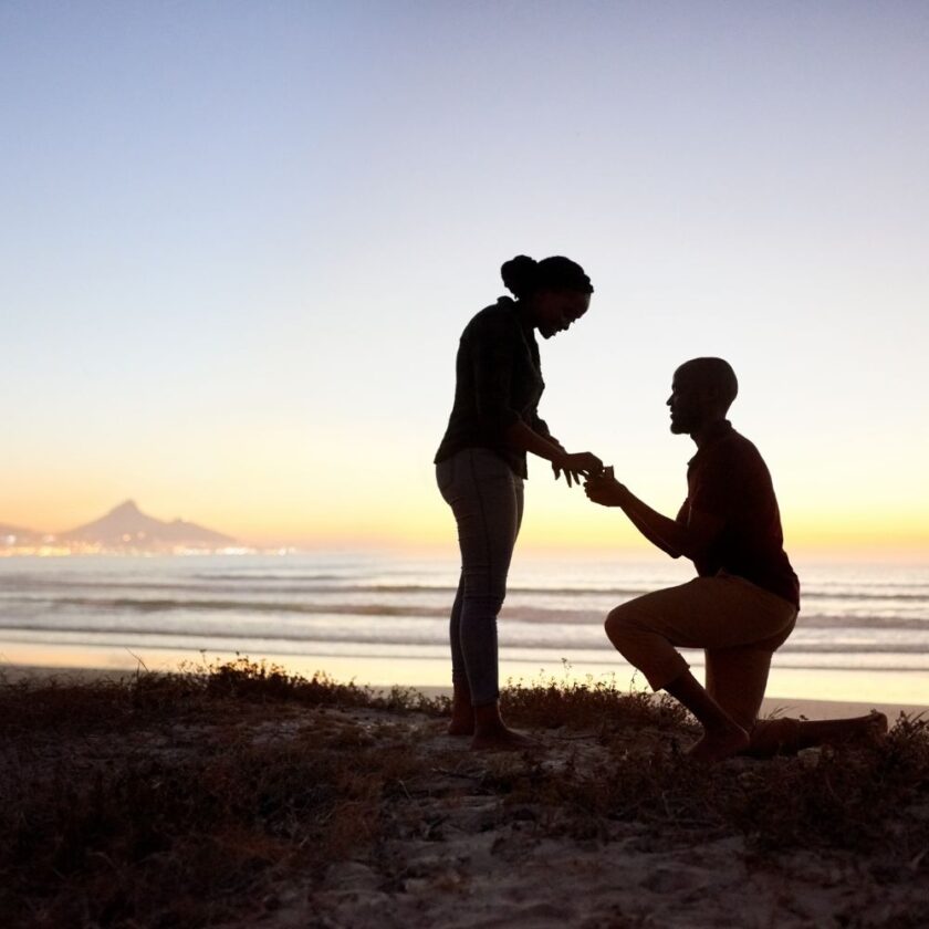 marriage proposal with a beach in the background