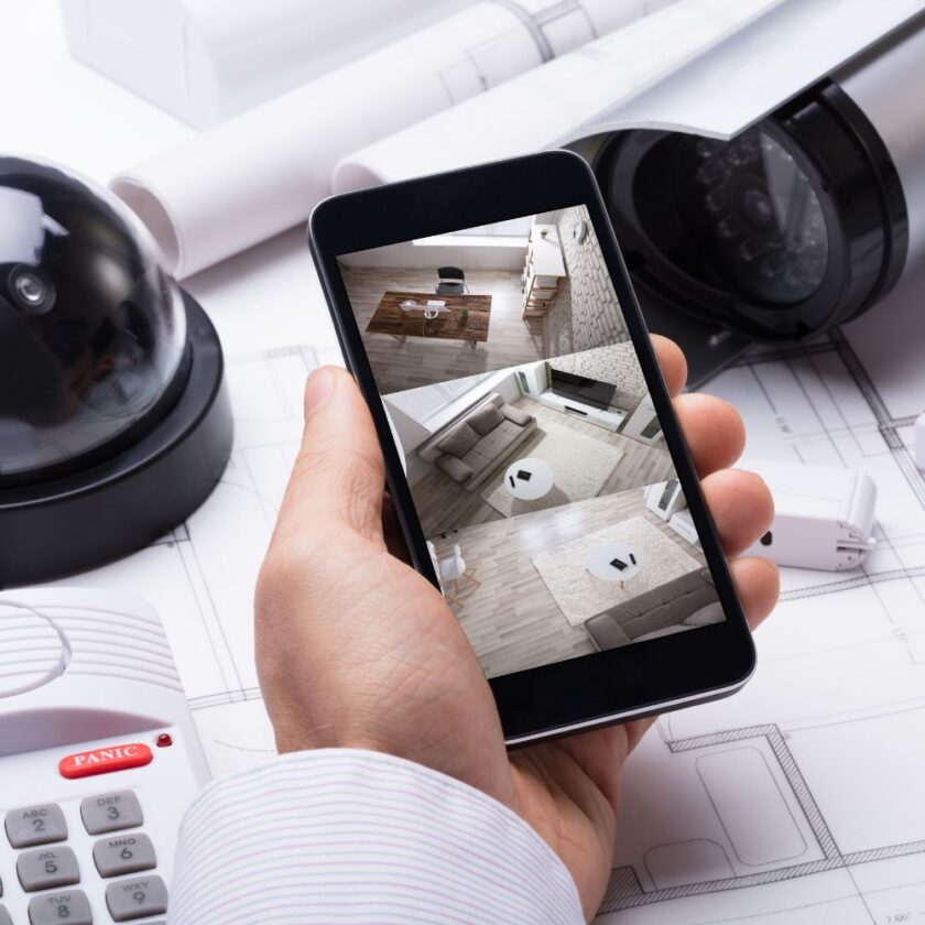person checking their home security system on a phone