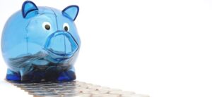 small blue piggy bank on the path to financial freedom