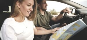 young couple planning a trip using a map