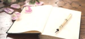 fountain pen on an open blank journal