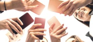 group of people looking at social media on their phones