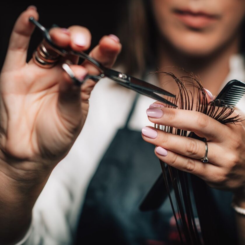 person getting their hair cut in a salon