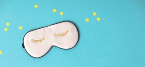 sleep mask against a blue background