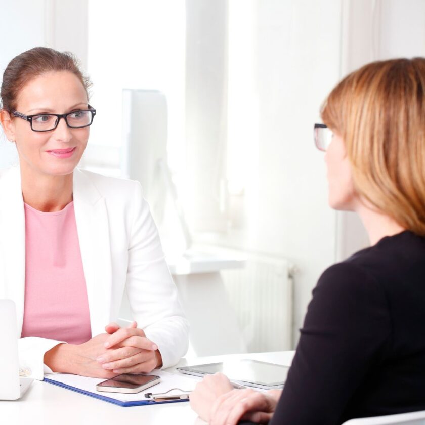 two woman talking perhaps in a job