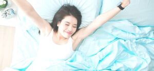 woman stretching in bed after a good nights sleep