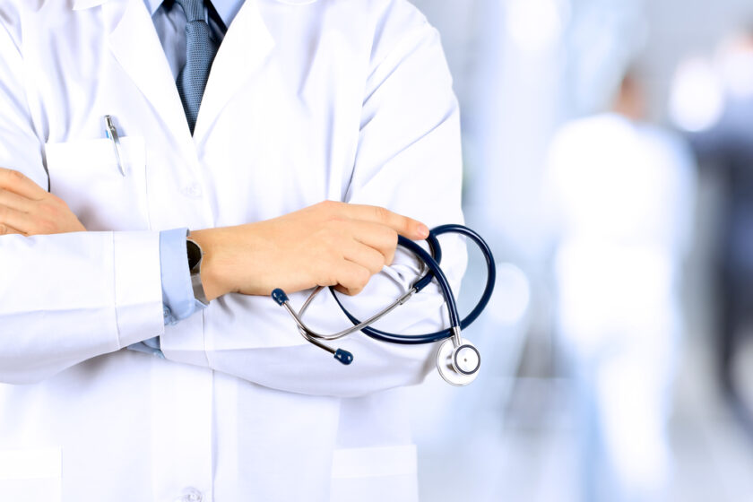 Portrait an unknown male doctor holding a stethoscope