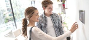 young couple setting their home cameras