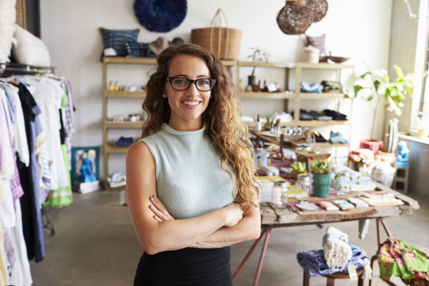 Young female business owner in a clothes shop, portrait
