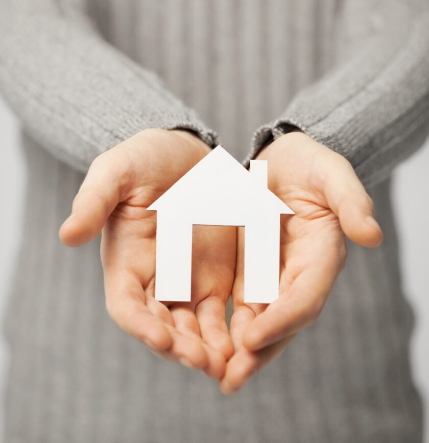 bright picture of man holding paper house