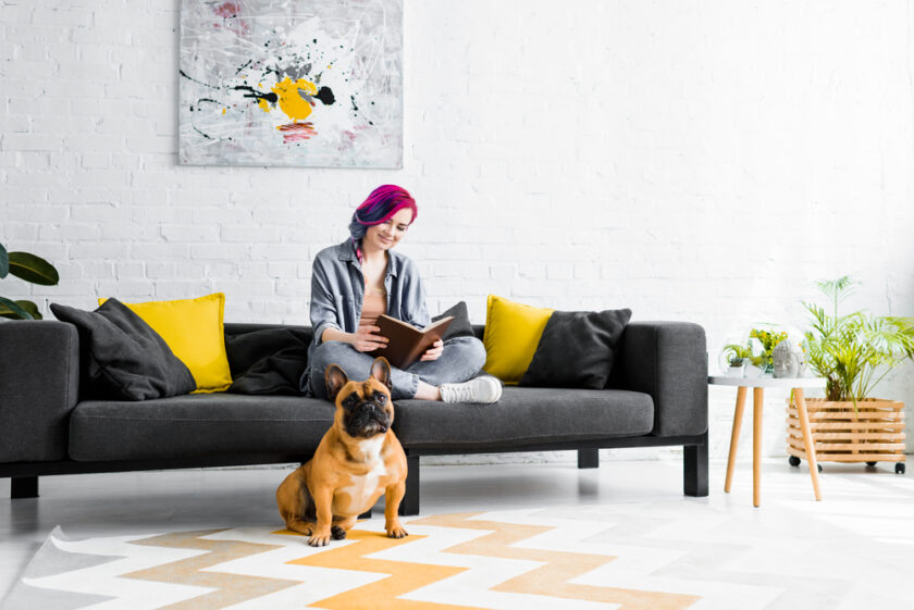 woman sat on her sofa in her home looking comfortable 