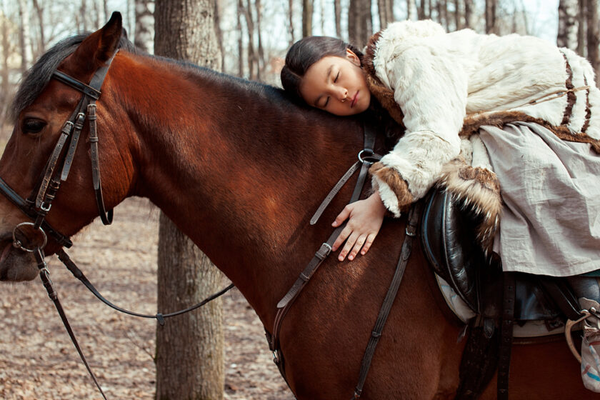 Woman sat on the back of a horse