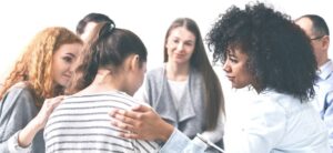 group therapy session with a women being comforted