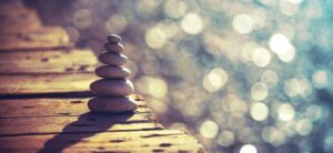stones balanced on a wood board walk