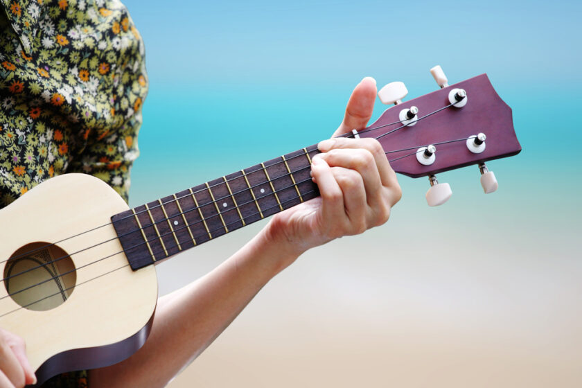 hand picking Guitar ,Ukulele on the beach.