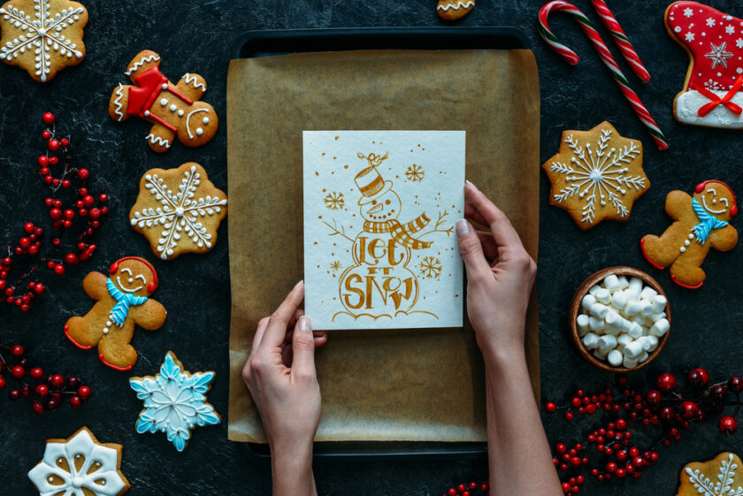 Person holding a christmas card saying let it snow