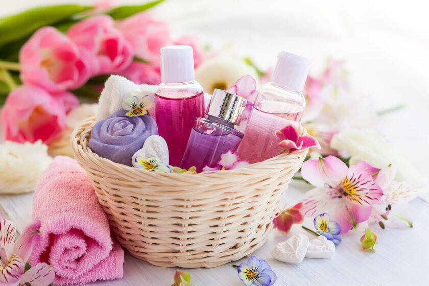 Spa bath toiletries set in basket with fresh flowers