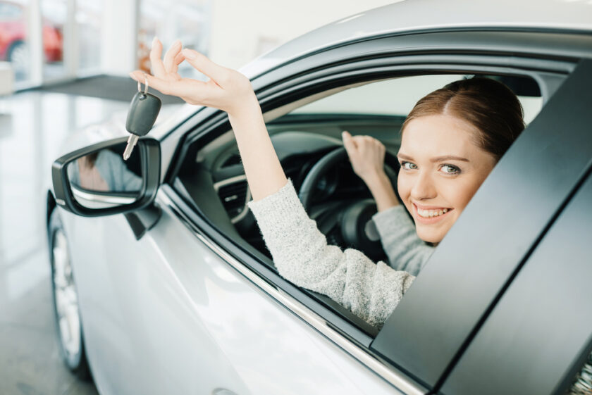 woman sat in a car holding keys