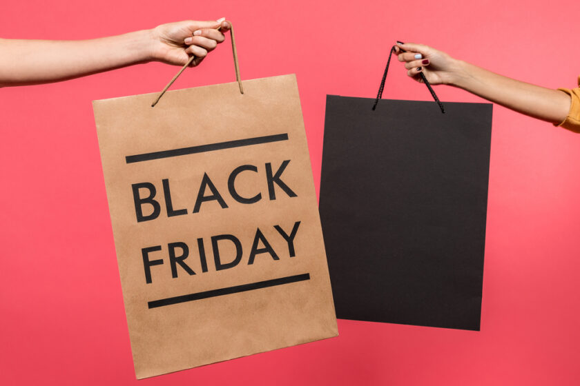 Two shopping bags one black and one brown with black friday written on it 