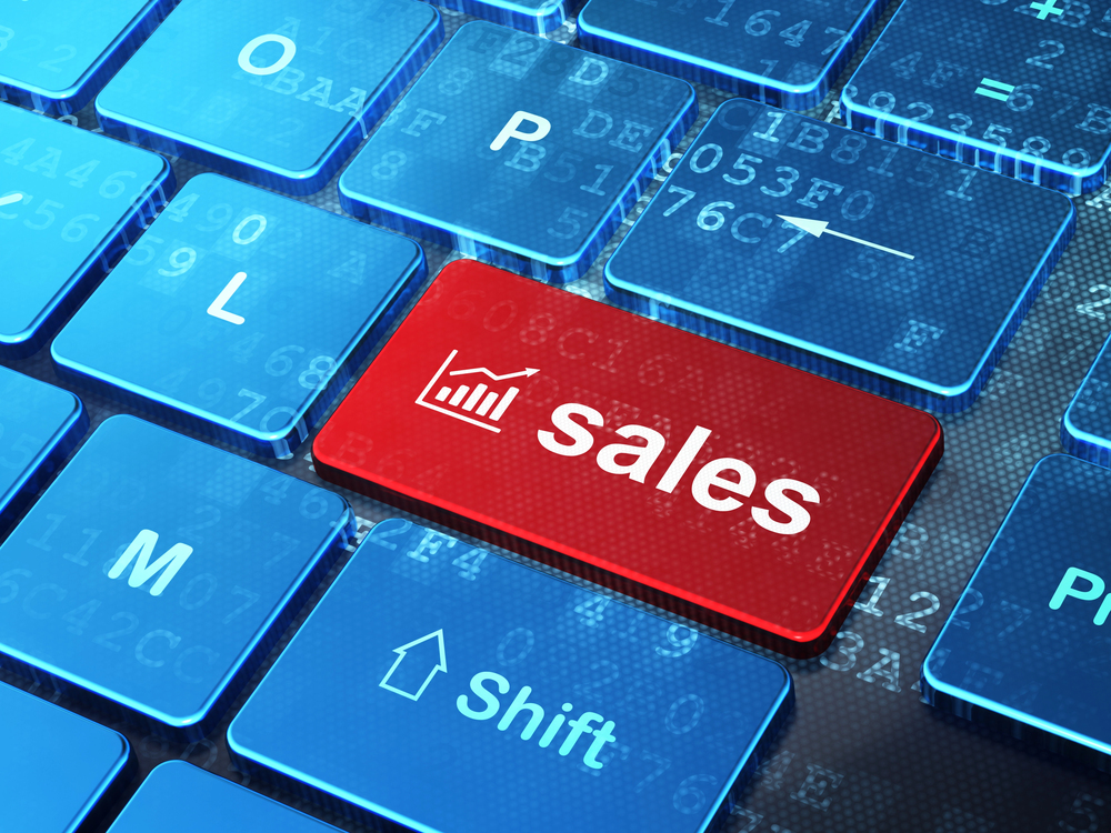 A red computer key labelled sales with a line graph icon, surrounded by blue backlit keys.