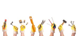 hands holding a range of tools