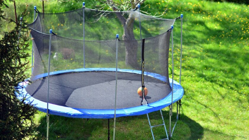 Trampoline in a back yard garden