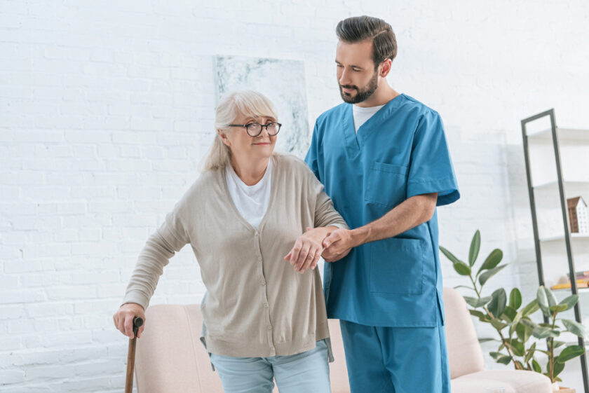 Older female being helped by a care worker