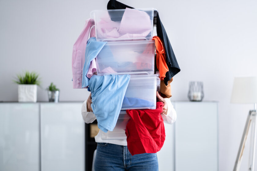 Woman Decluttering And Doing Laundry At Home