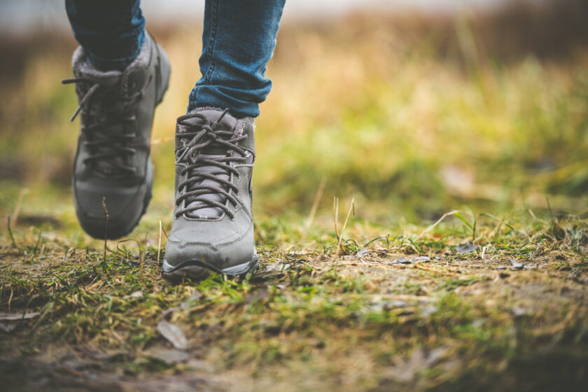 feet in shoes on a forest path