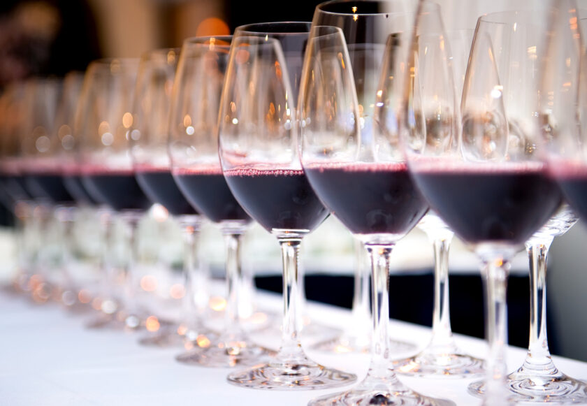 Glasses of red wine in a row on a table