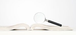 book and magnifying glass