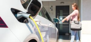 person charging their car at home