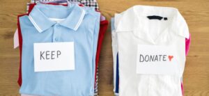 plie of clothes to keep and a pile to donate