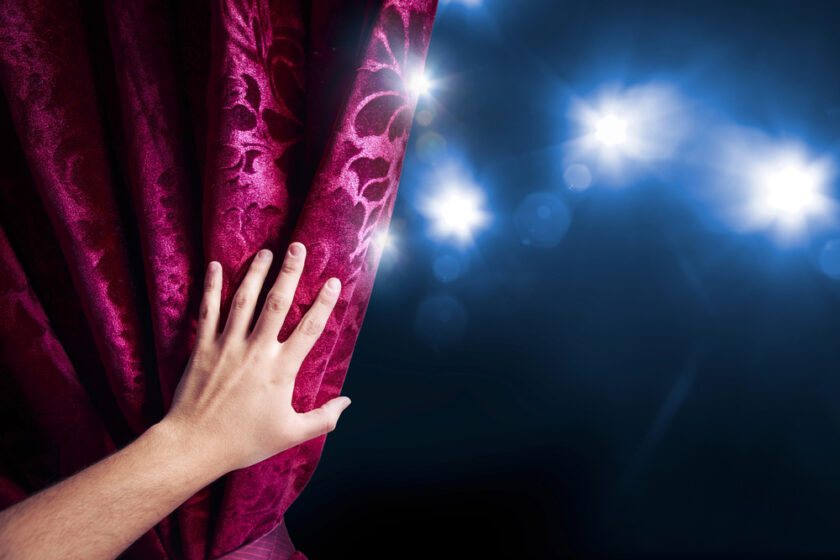 Hand on a velvet curtain