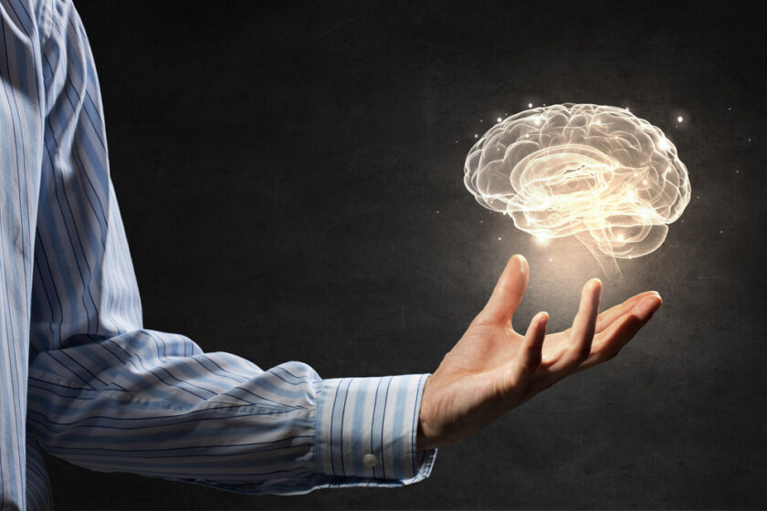 Close up of human hand holding brain symbiol