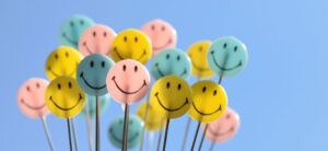 group of happy faces on sticks