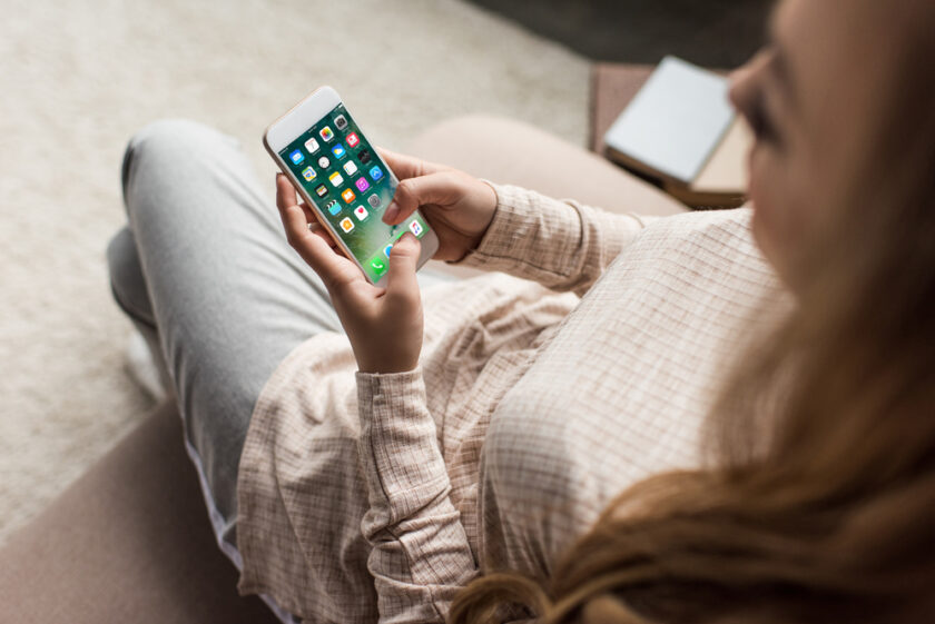 Woman look at a mobile phone with apps on it