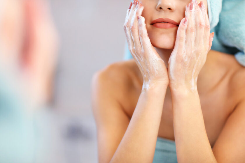 Picture showing young woman looking in bathroom mirror