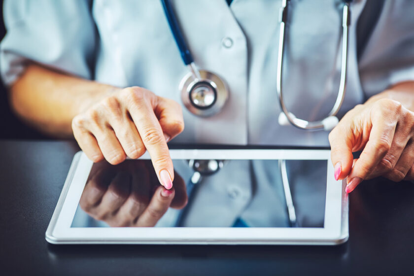 Woman doctor using tablet computer in hospital
