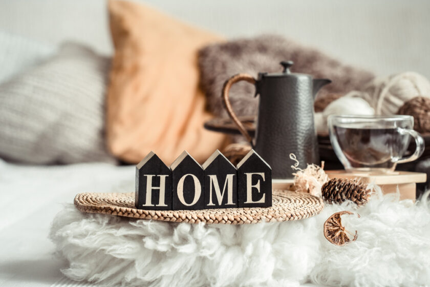 Still life home decor in a cozy house with wooden letters with the inscription home. The concept of decor and comfort .