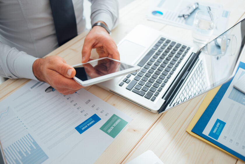 Professional businessman working at desk and using a touch screen tablet, technology and communication concept