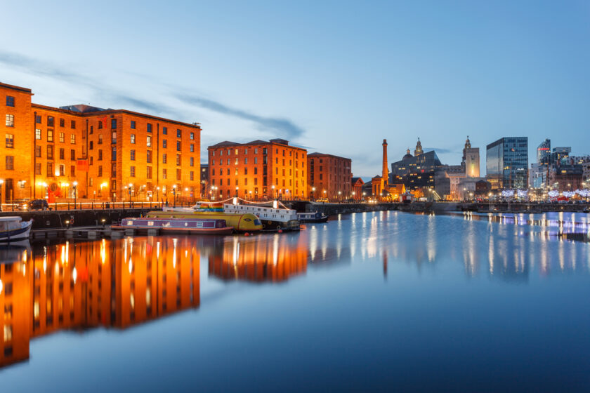 Reflections of old buildings at Albert Dock, Liverpool waterfront, UK.