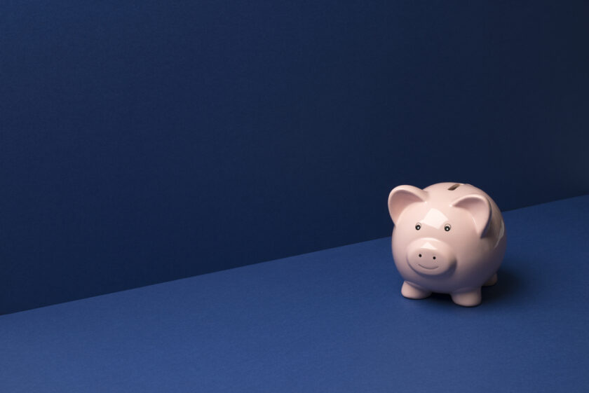Piggy coin bank on a blue wall and floor background