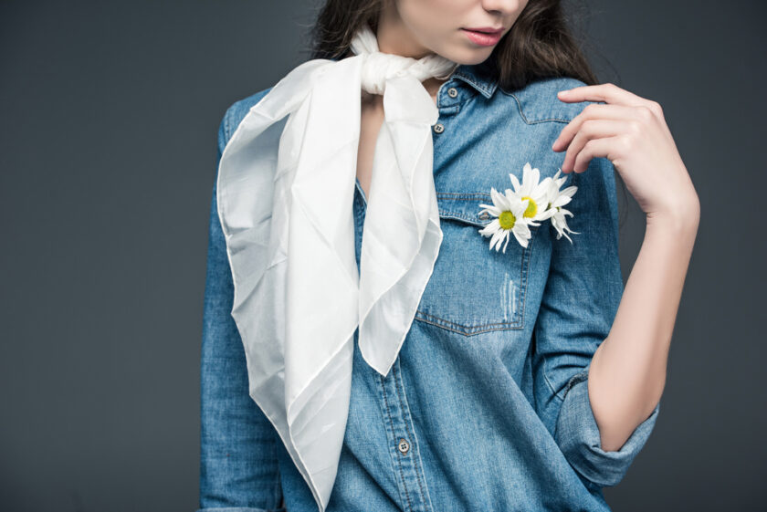 Woman wearing a white scarf and white flower