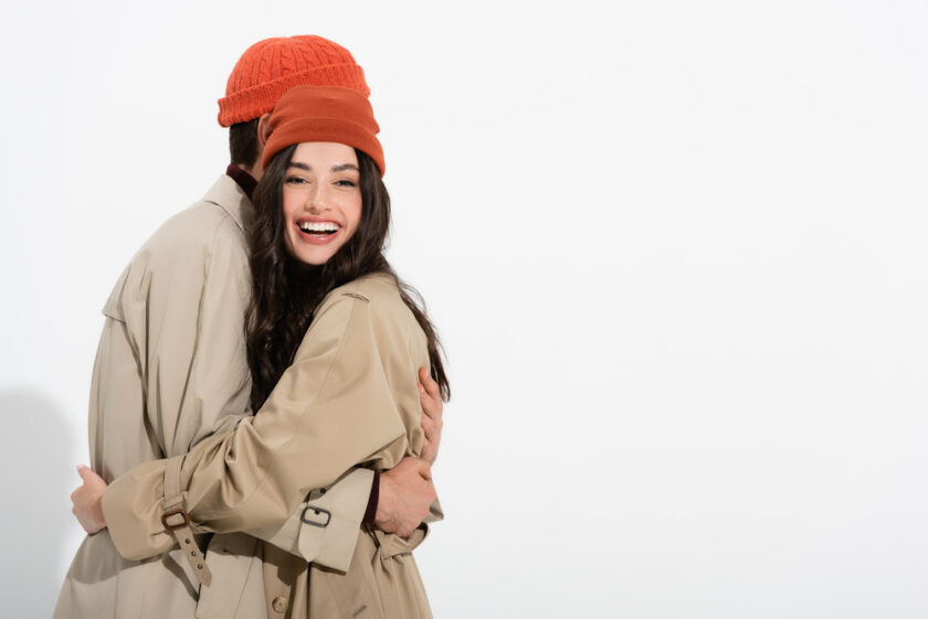 Man and woman wearing a red beanie